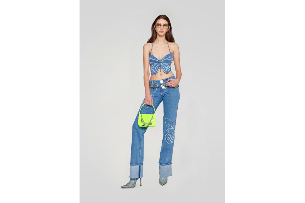Model in denim butterfly top and embroidered jeans