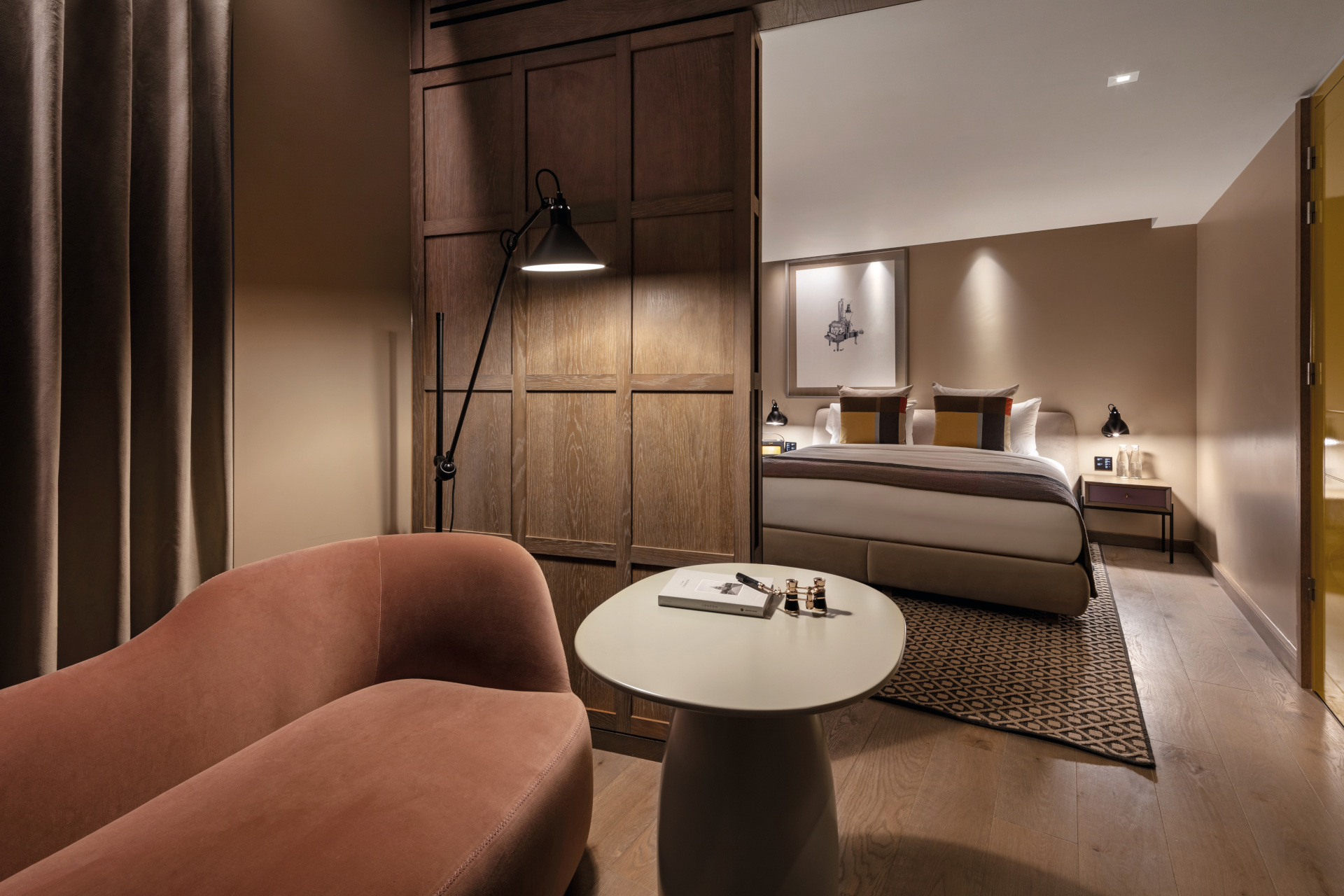 Junior Suite, sofa with side table and doorway leading to bedroom