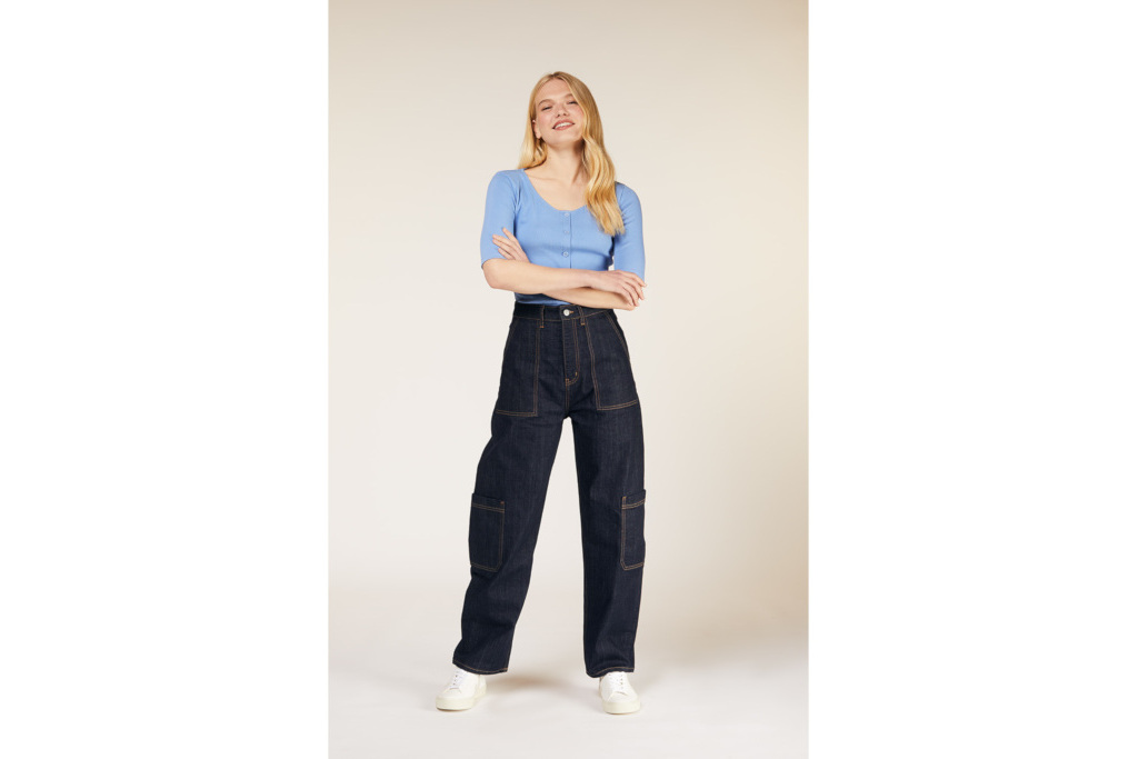 Model in blue top and cargo jeans