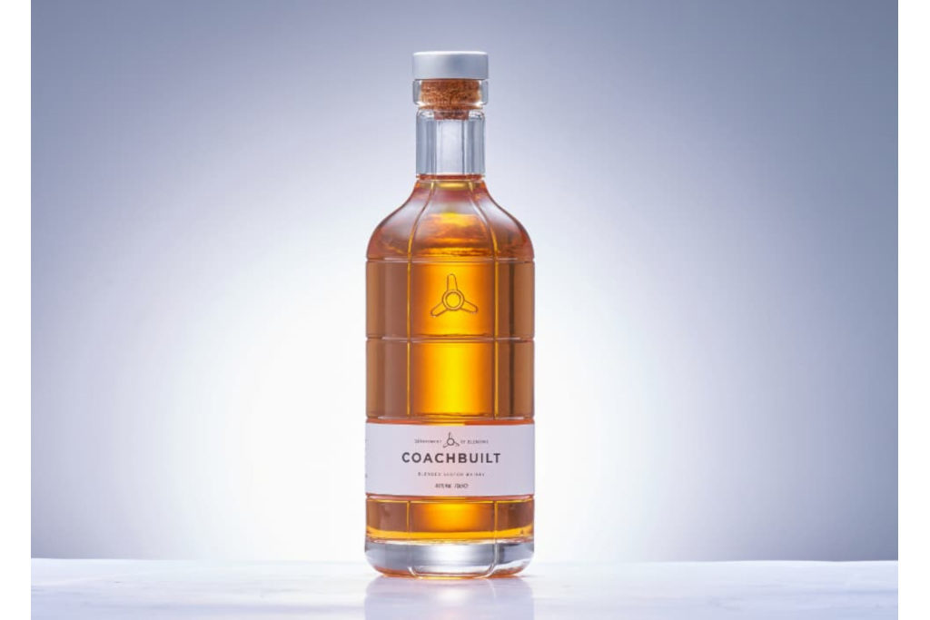 Bottle of Coachbuilt Whisky on a white table