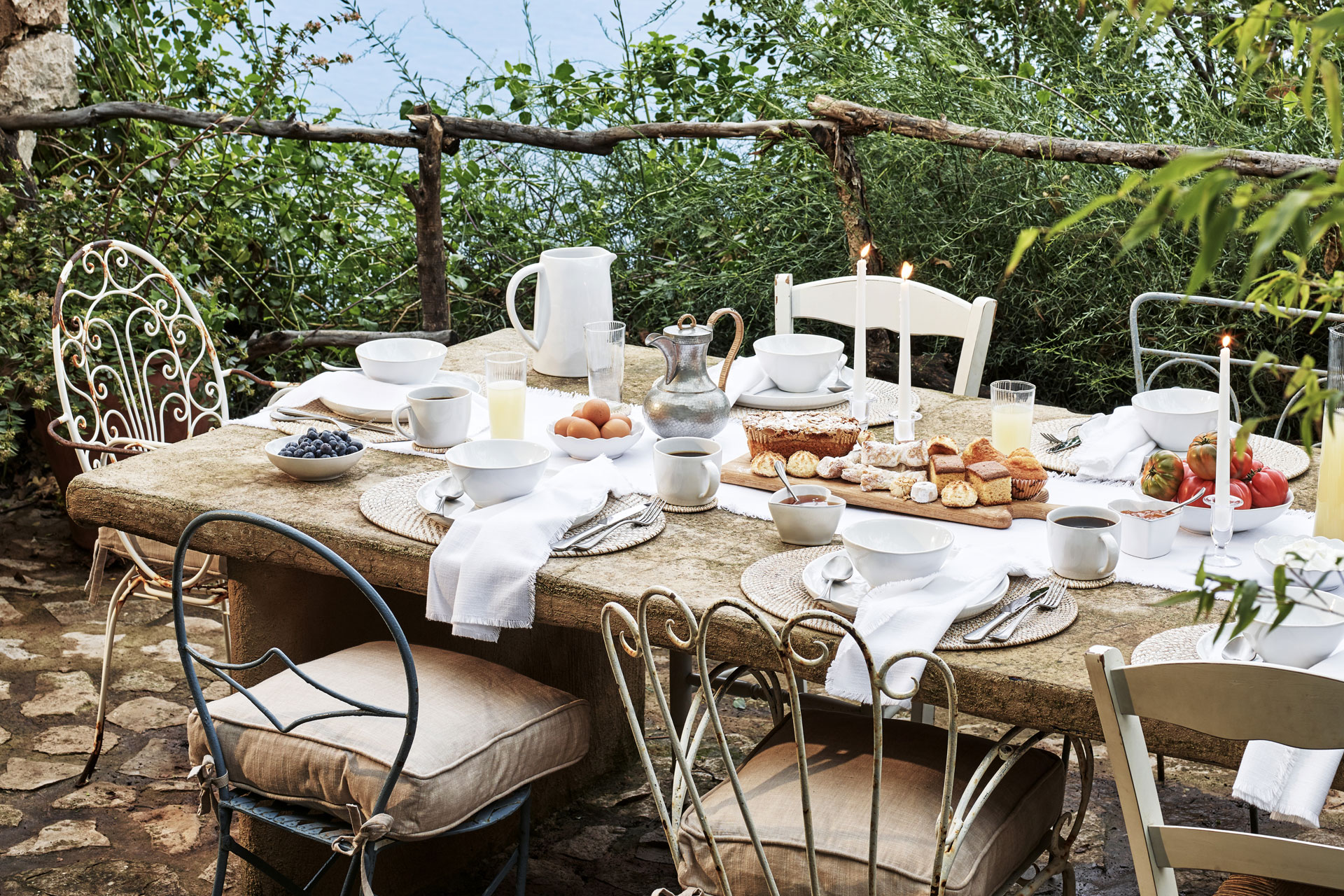 an image of a table al fresco facing the sea with rustic charm