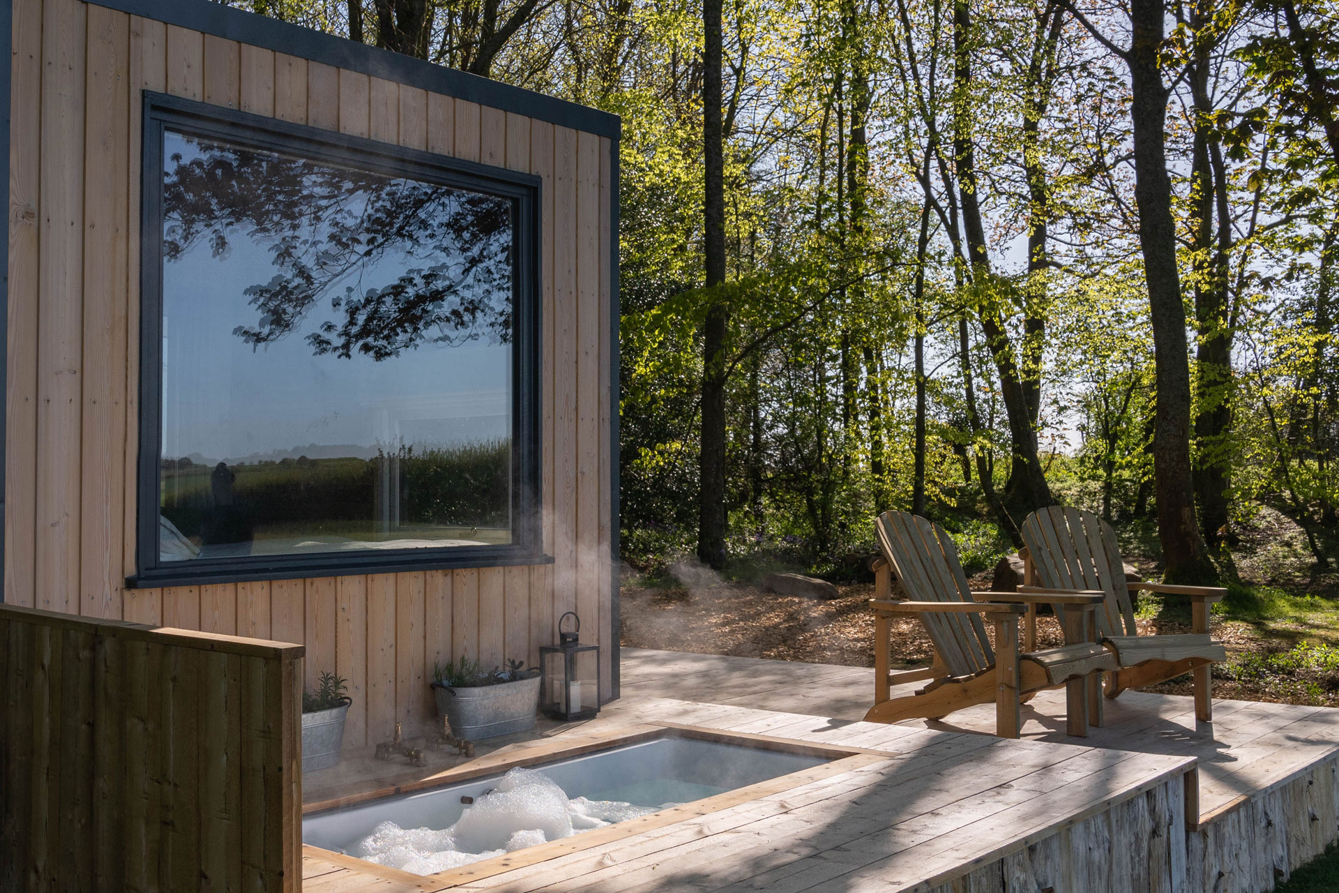 a glamping holiday in the UK called Cedars Kabin, with a forest and a wooden sauna as part of the accommodation