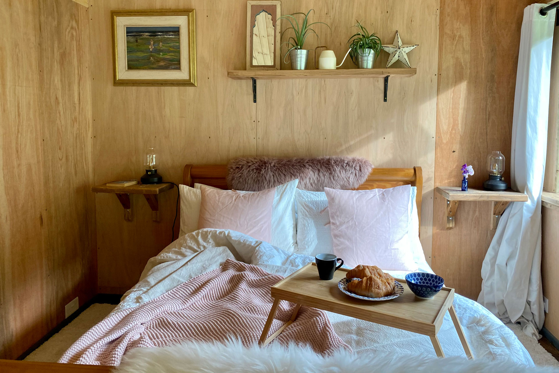 breakfast in bed in a wood panelled glamping hut called Hills Cross Hide