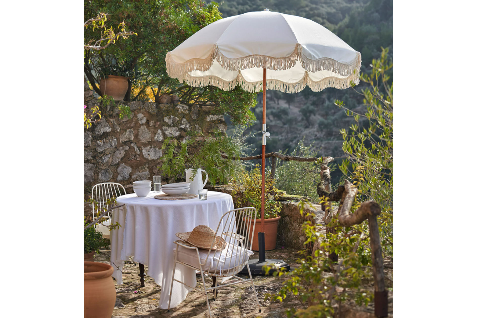 a premium white umbrella outdoors by The White Company