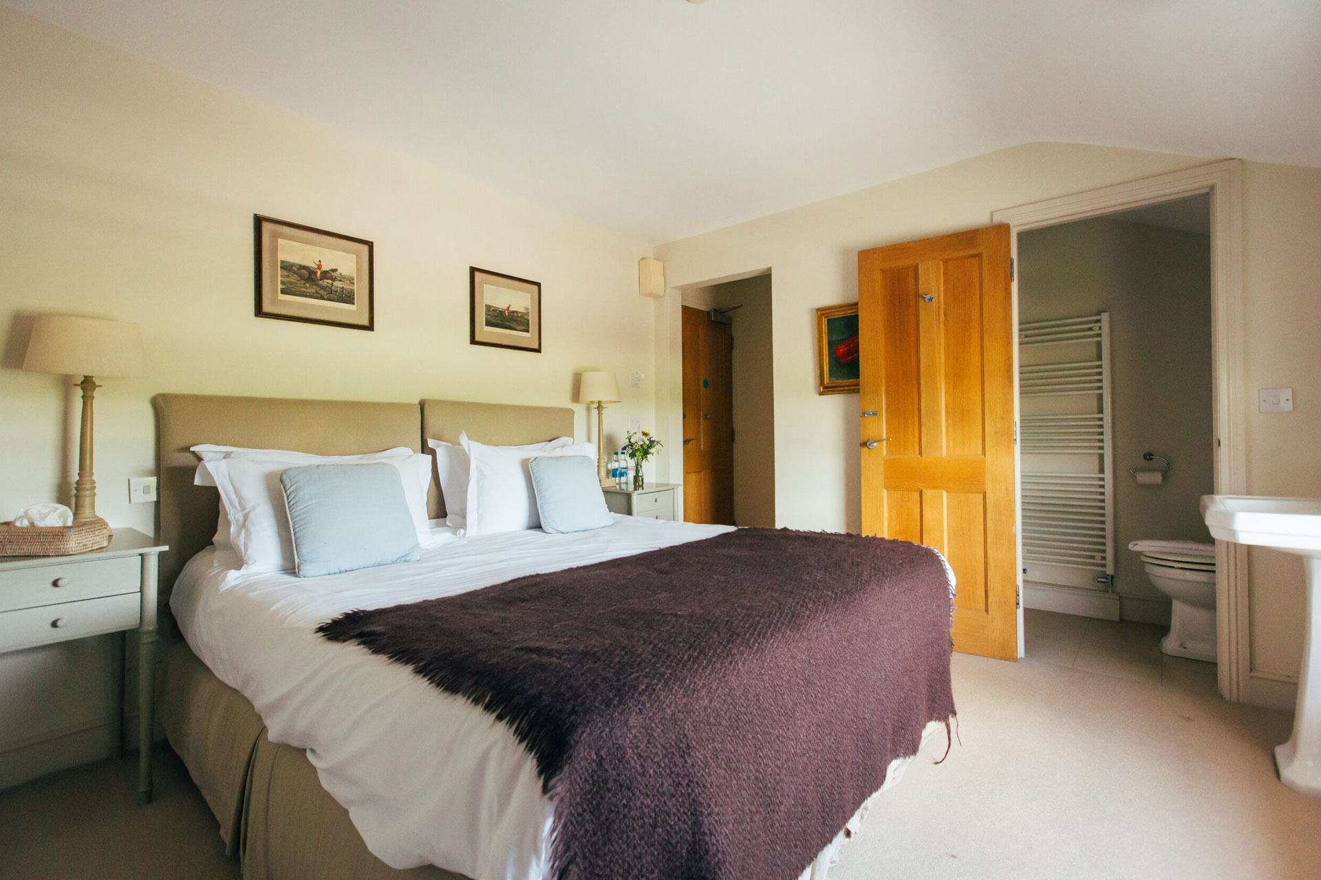 A bedroom - purple bedspread across a double bed