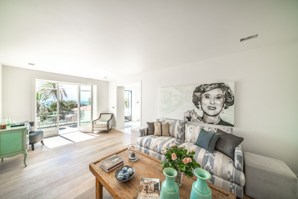 french villa reception room with cream and neutral interiors and estee lauder picture