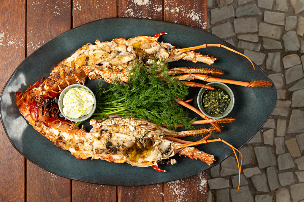 fish and greens on plate with dips