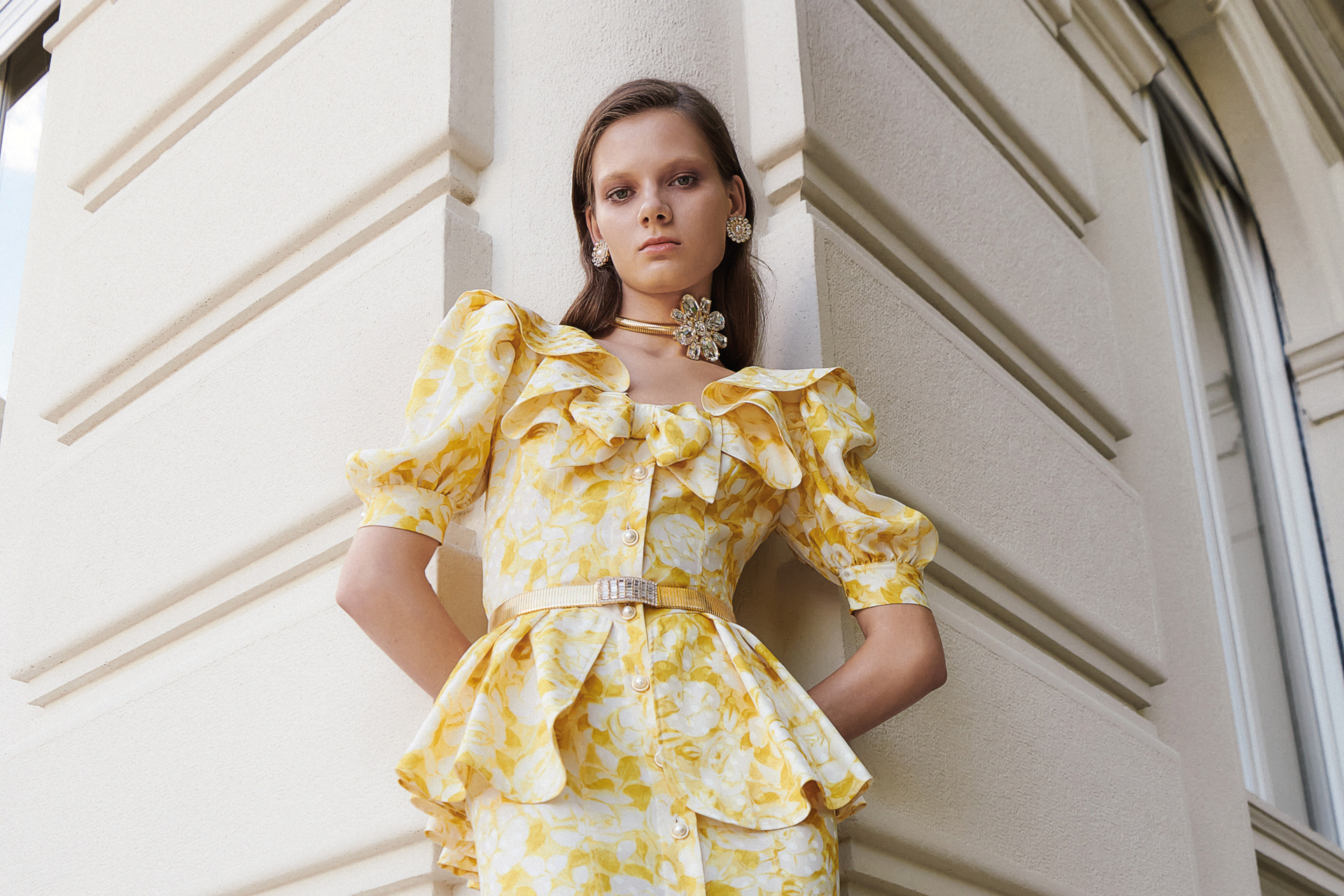 Woman in yellow floral patterned peplum dress