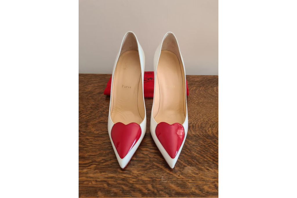 White shoes with red hearts on the front