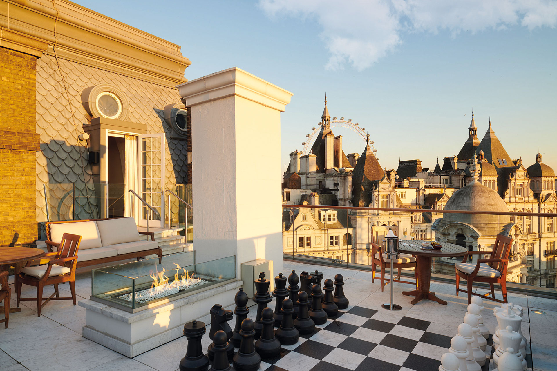 The skyline of London as seen from a rooftop, giant chess pieces