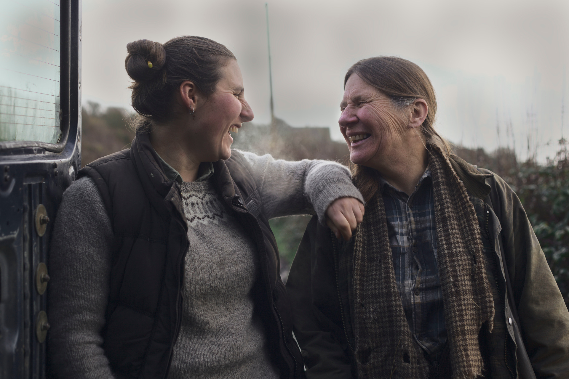 Two women laughing together outdoors