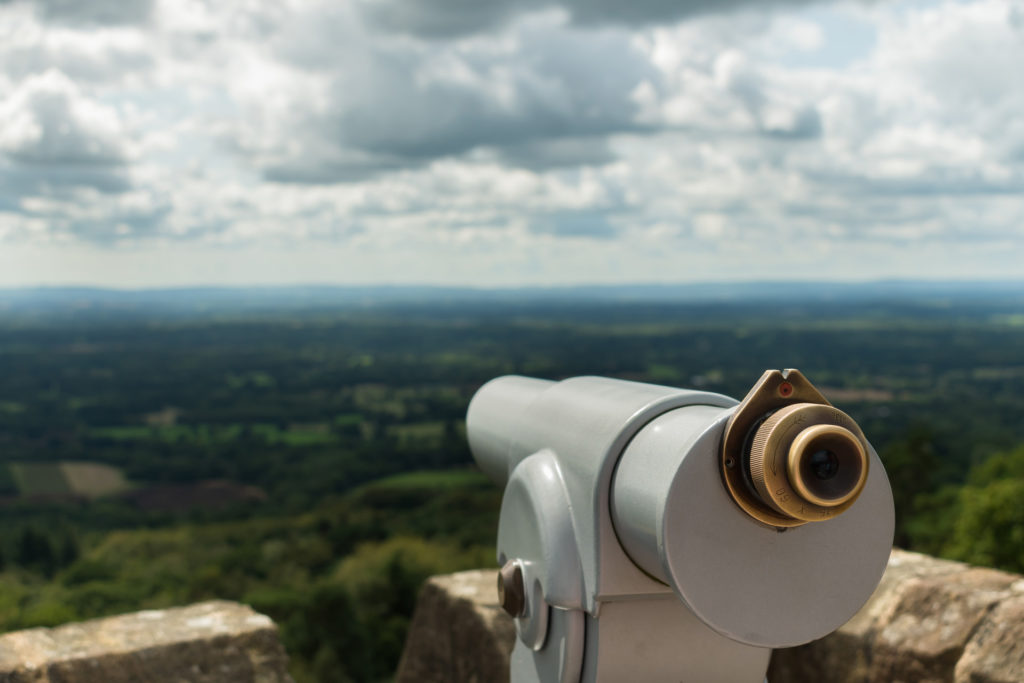 Looking out from a telescope view point across the Surrey and Sussex countryside from the North Downs to the South Downs. Taken from the top of Leith Hill Tower in England, UK