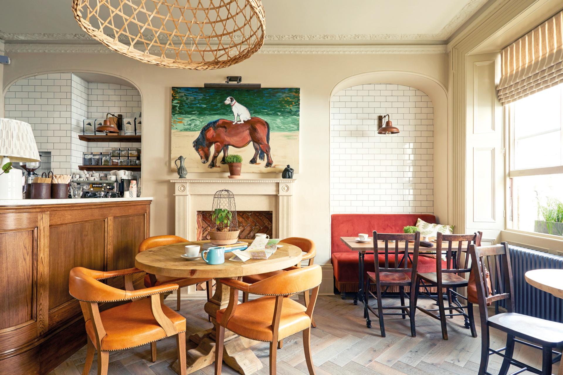 Warm toned dining area with tile walls and orange chairs