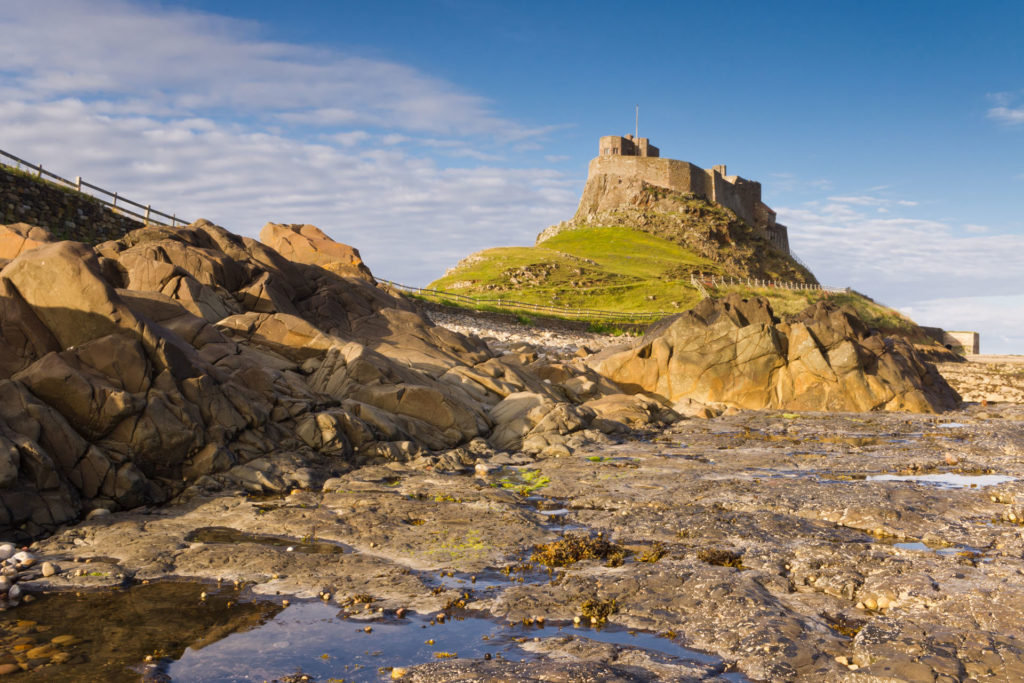 Lindisfarne Castle from the Rocks with rock pool in foreground