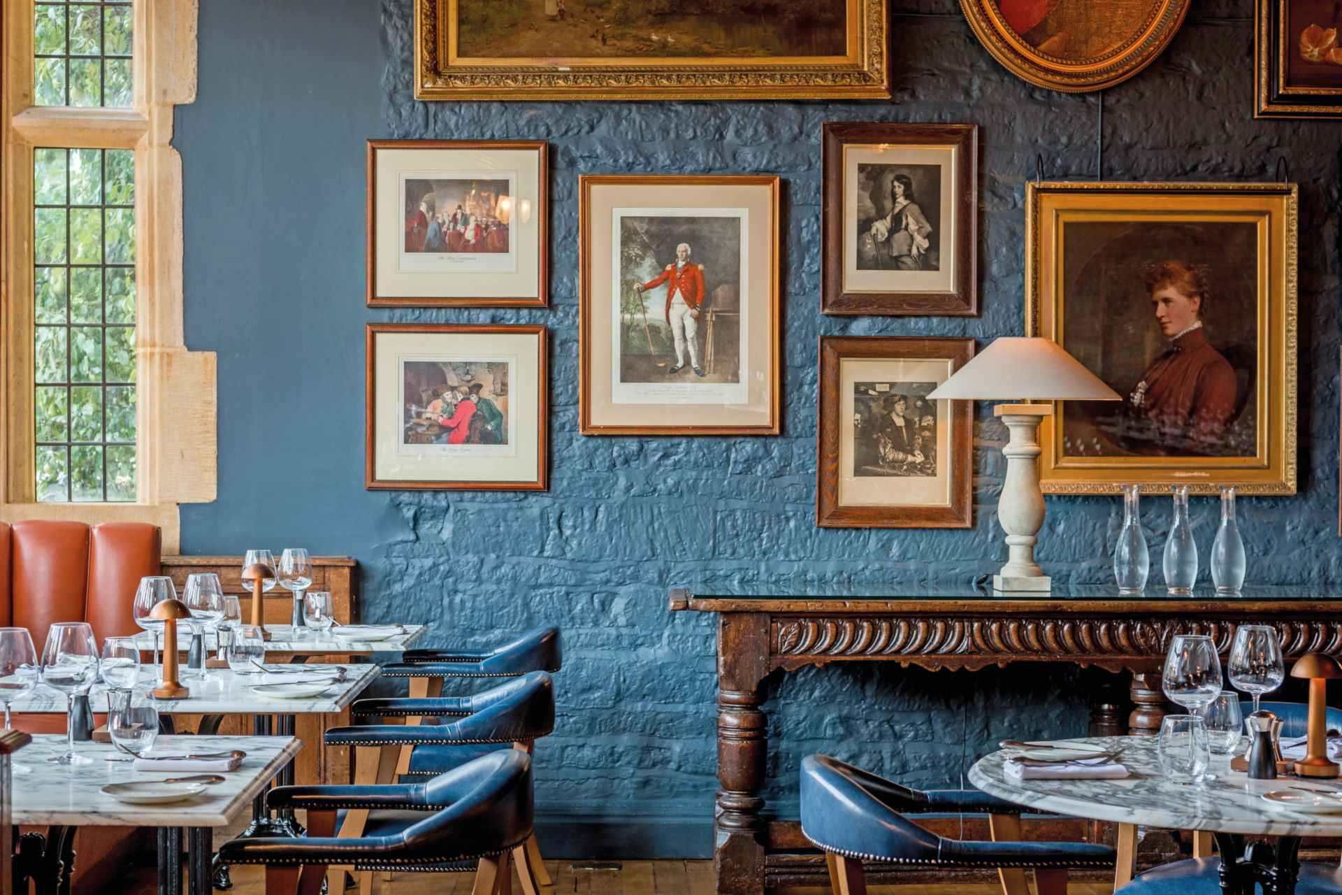 Blue wall with framed portraits