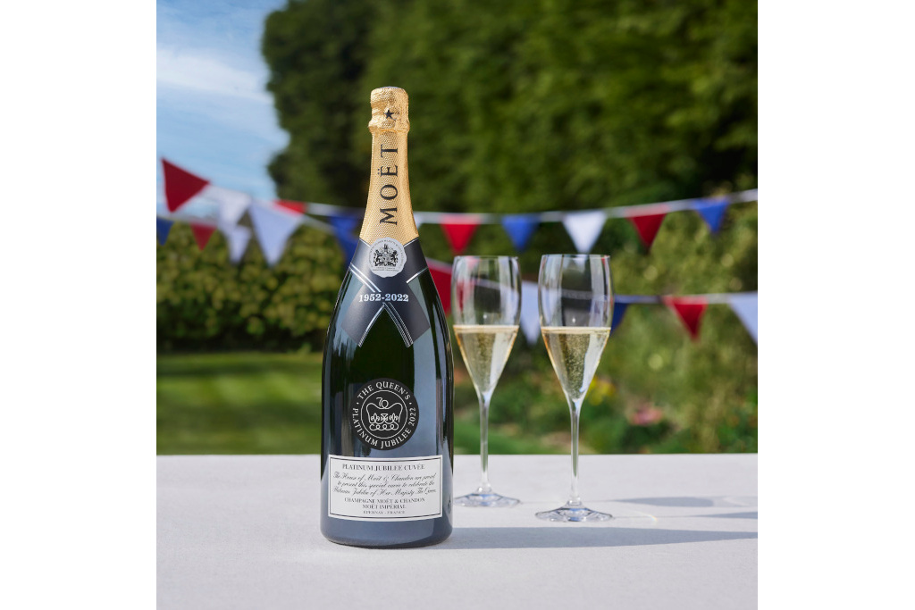 Platinum Jubilee Cuvée x Moët Impérial on table with glasses and bunting in the background