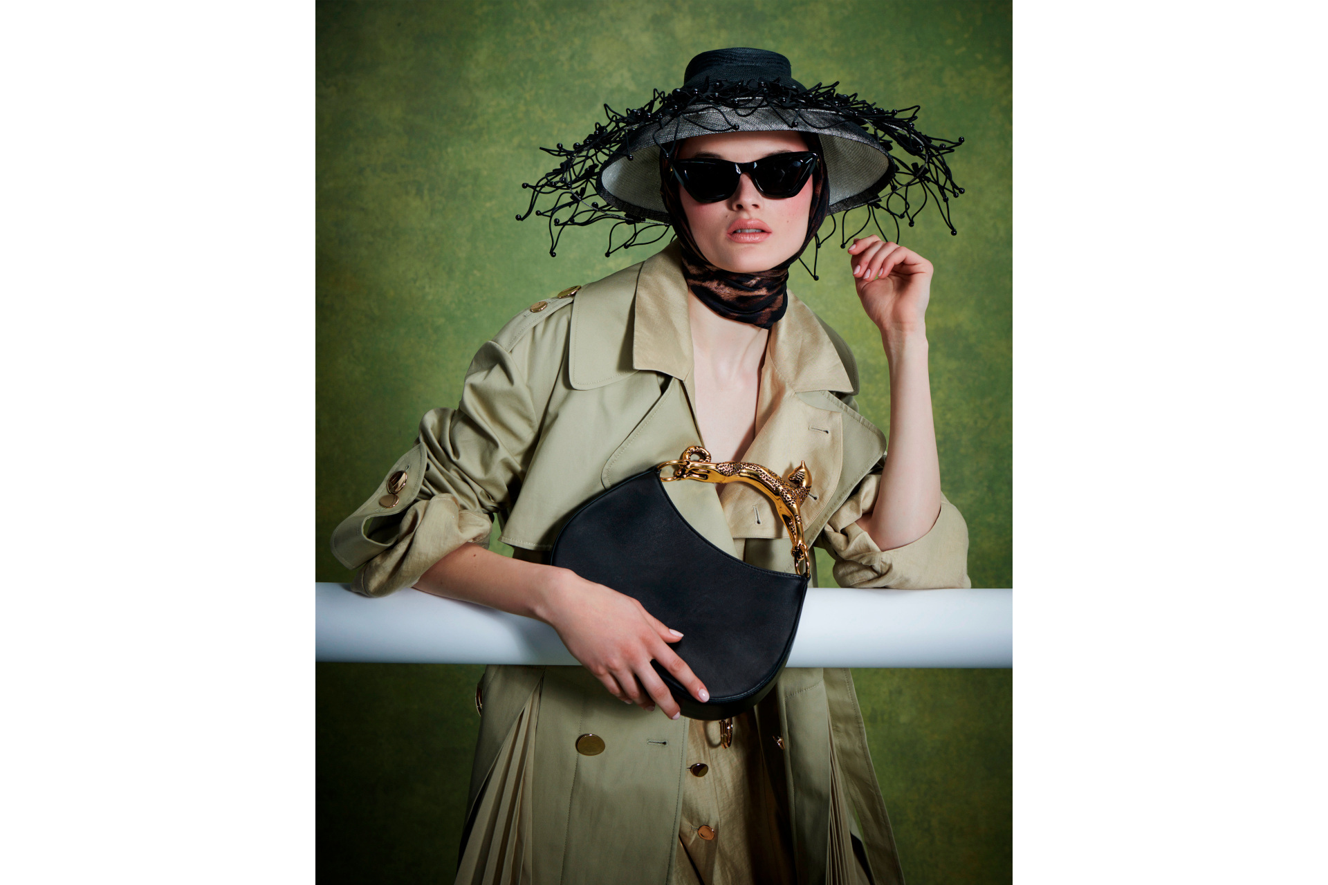 Woman in black hat, sunglasses and a trench coat