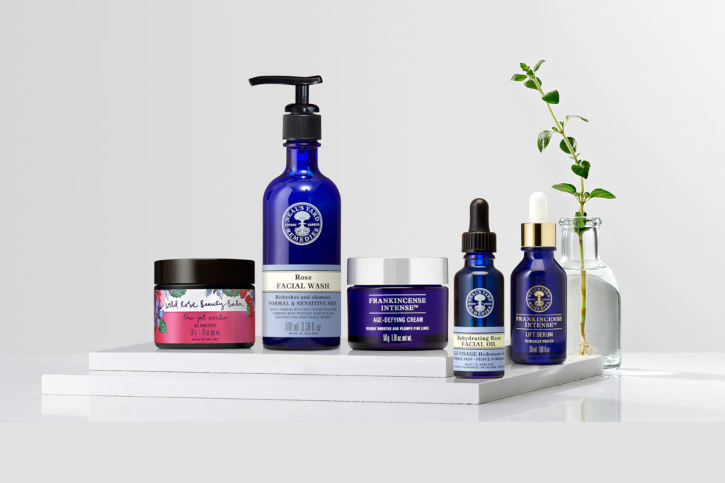 Skincare products lined up on white platform