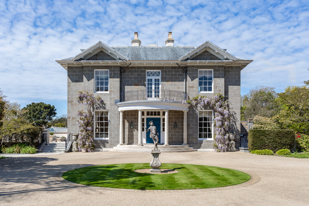 georgian grey double fronted house with wisteria in guernsey