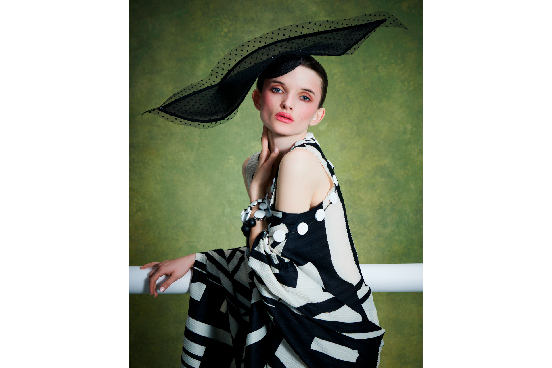 Woman wearing black hat and black and white dress