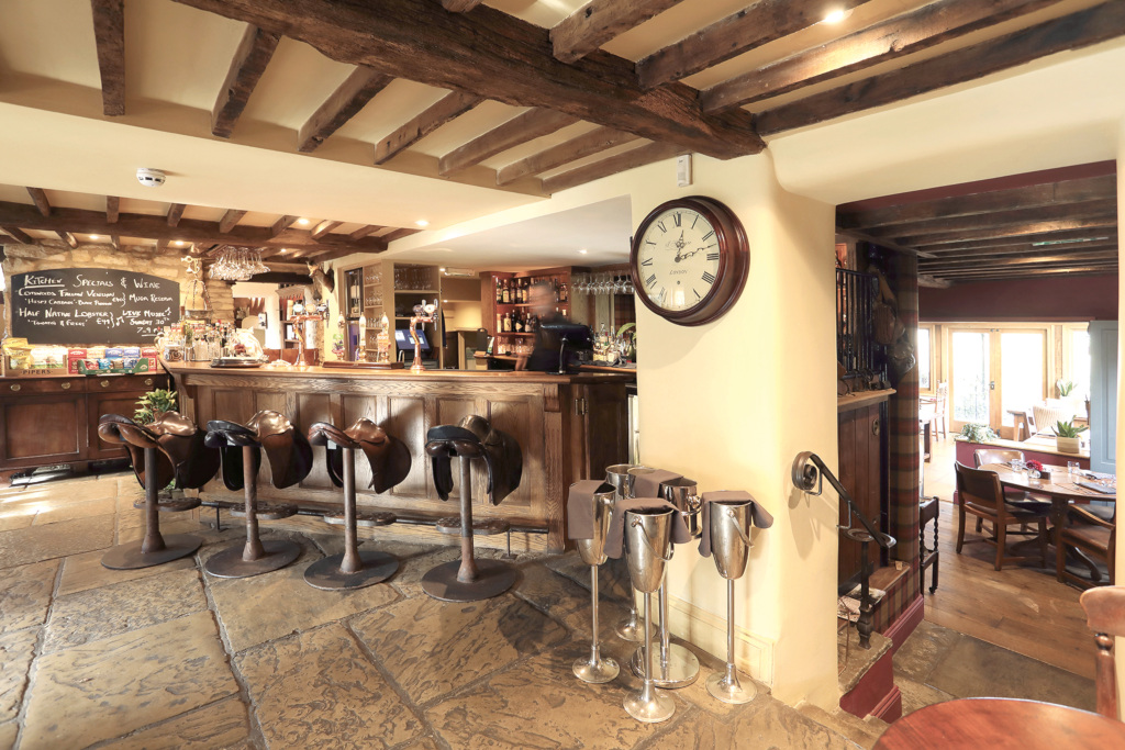 Pub dining room with stone floors and exposed beam ceilings