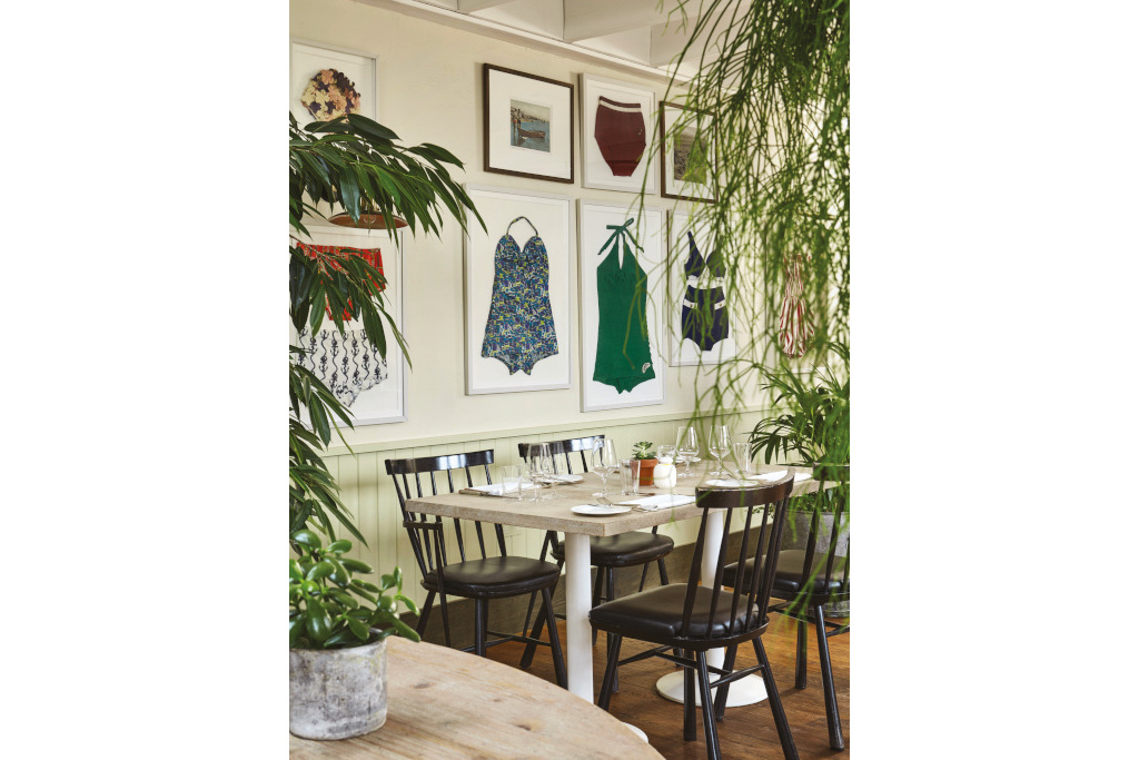 Dining area with framed swimsuits on the wall