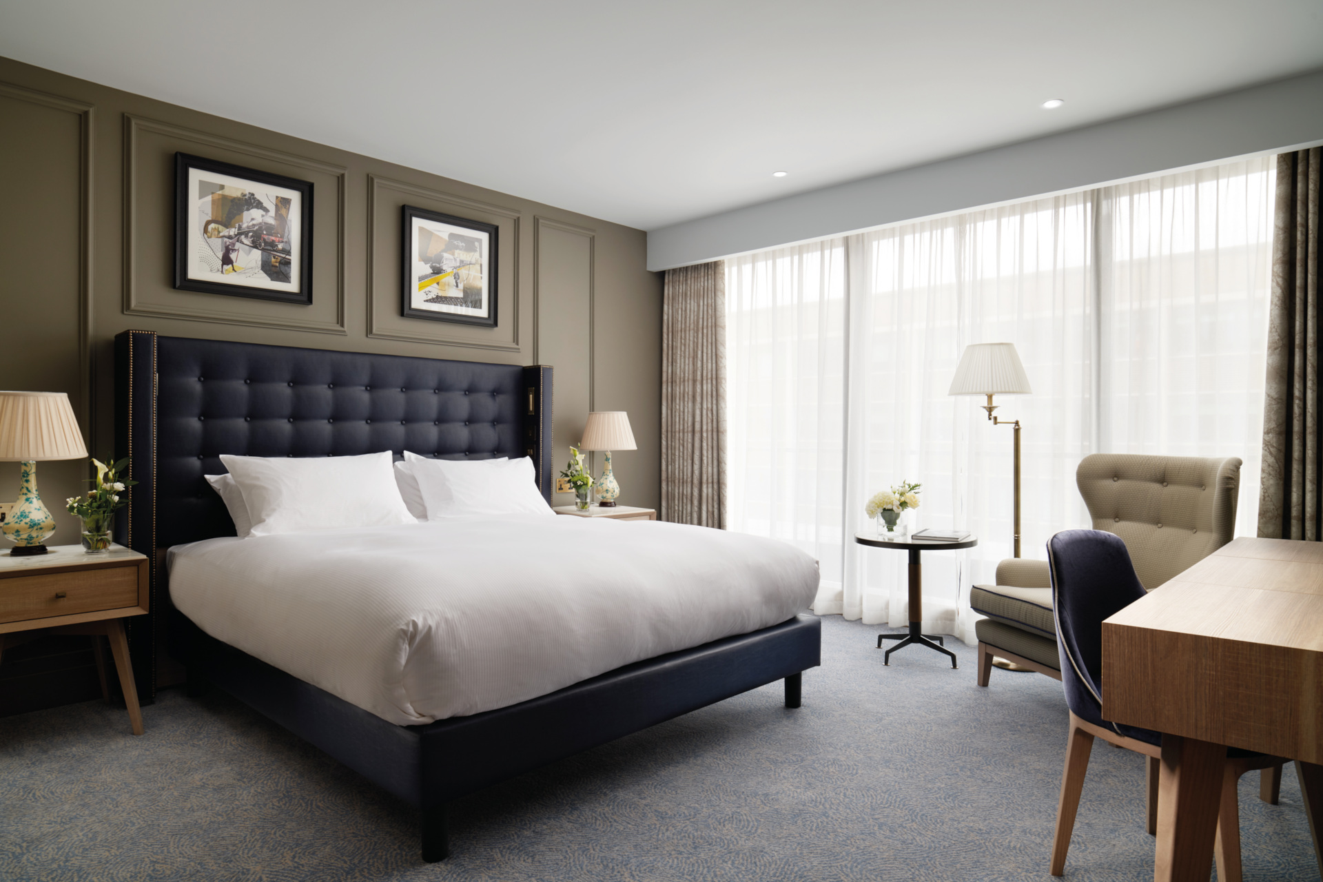 Hotel bedroom with dark green walls and large bed