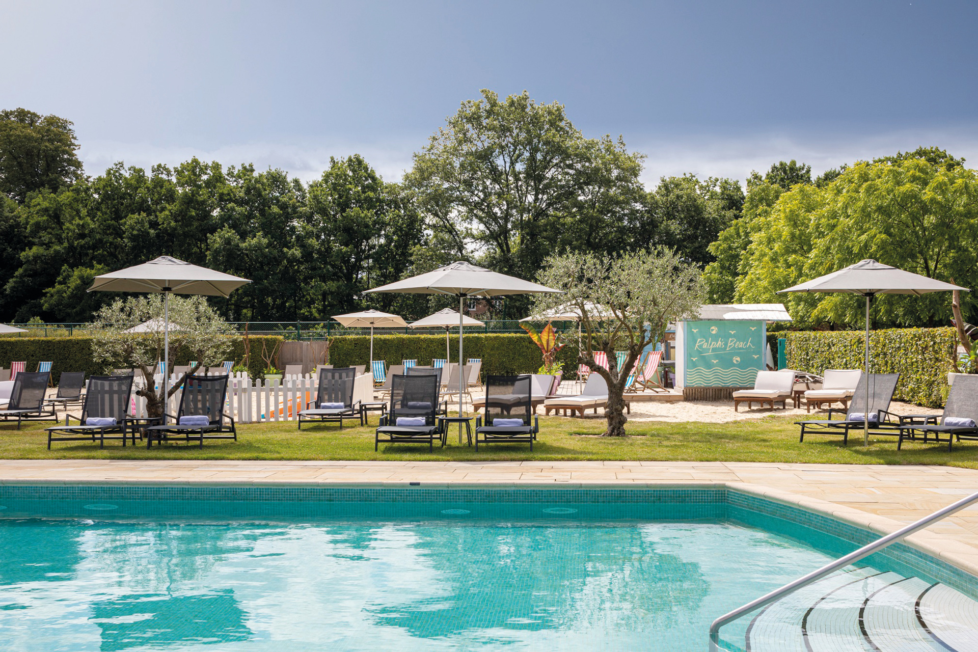 Outdoor pool with loungers and umbrellas
