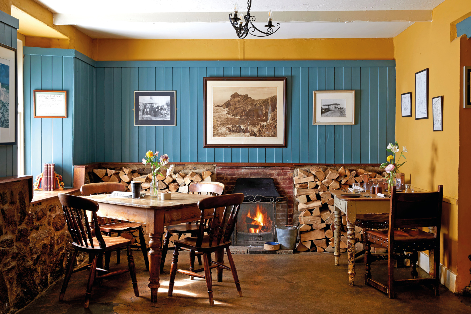 Blue and yellow dining room with fire and wooden floors