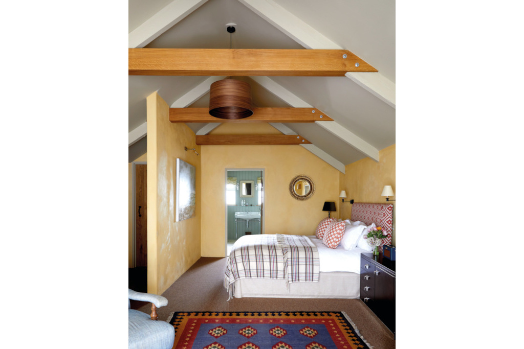 Light yellow bedroom with beam ceilings