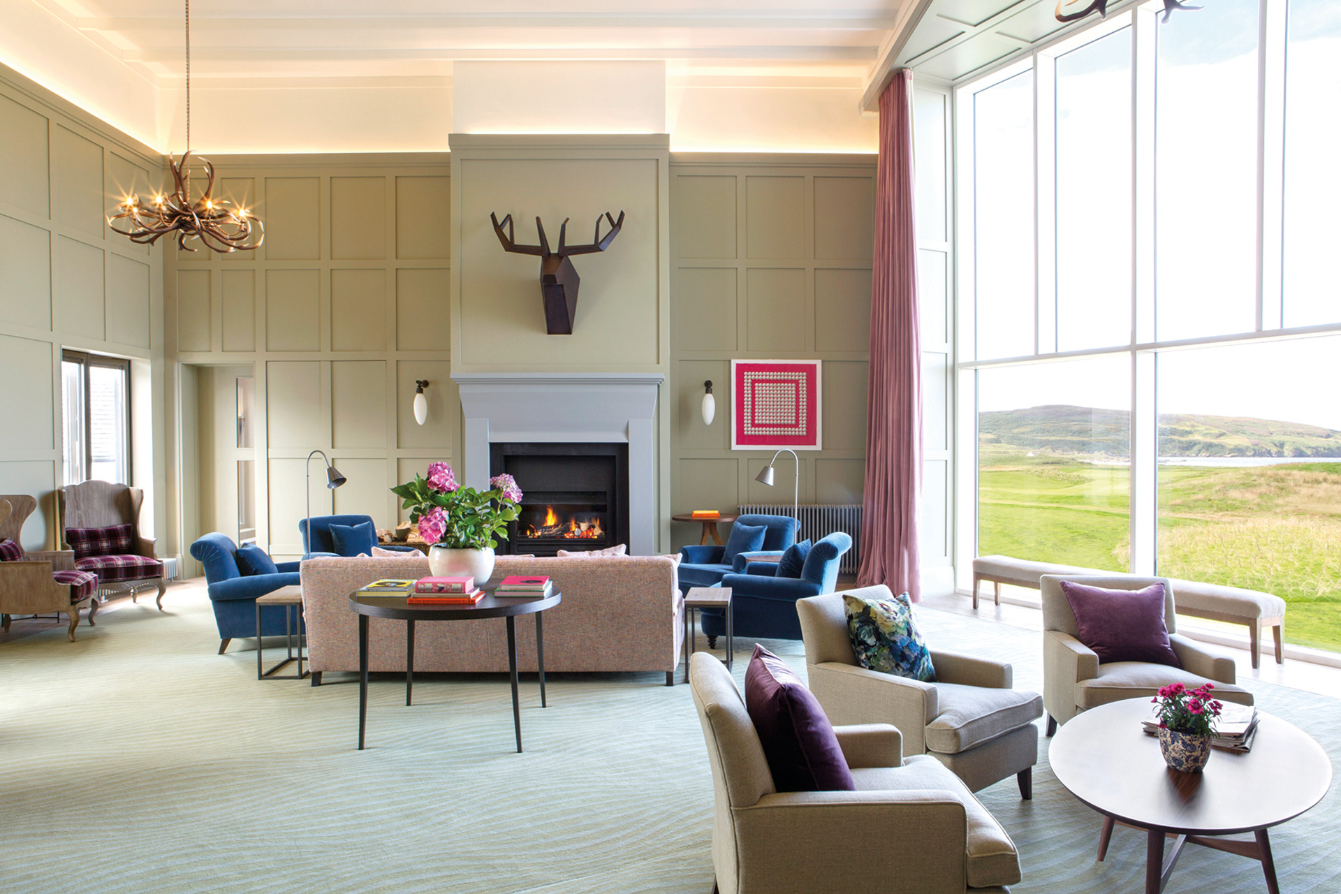 Lounge with wide windows and colourful furnishings