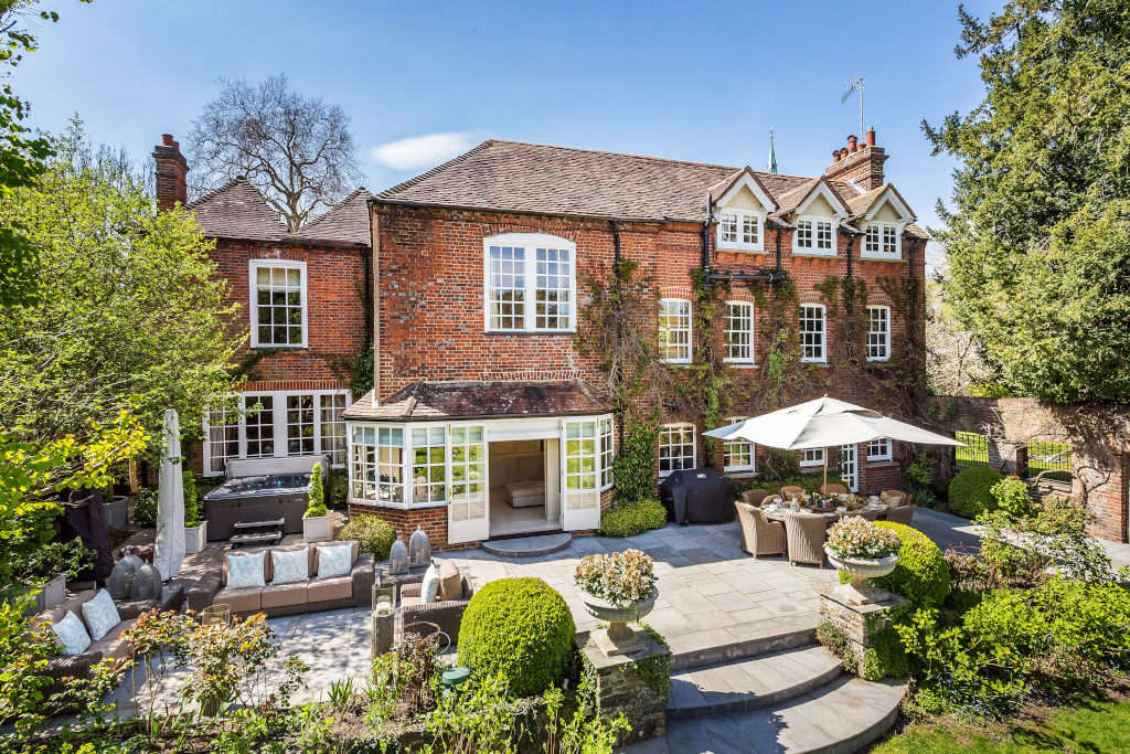 back of house on The Street, Shalford, Guildford, Surrey. red brick and wisteria clad, patio garden area with alfresco area.