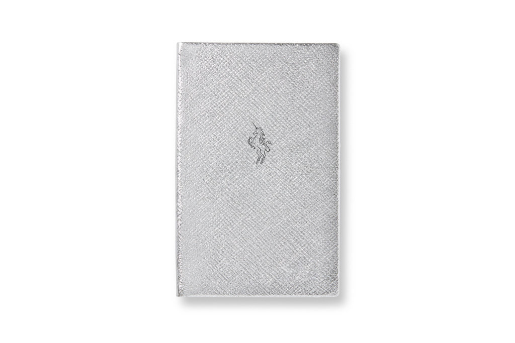 Silver notebook with black stamp depicting a unicorn