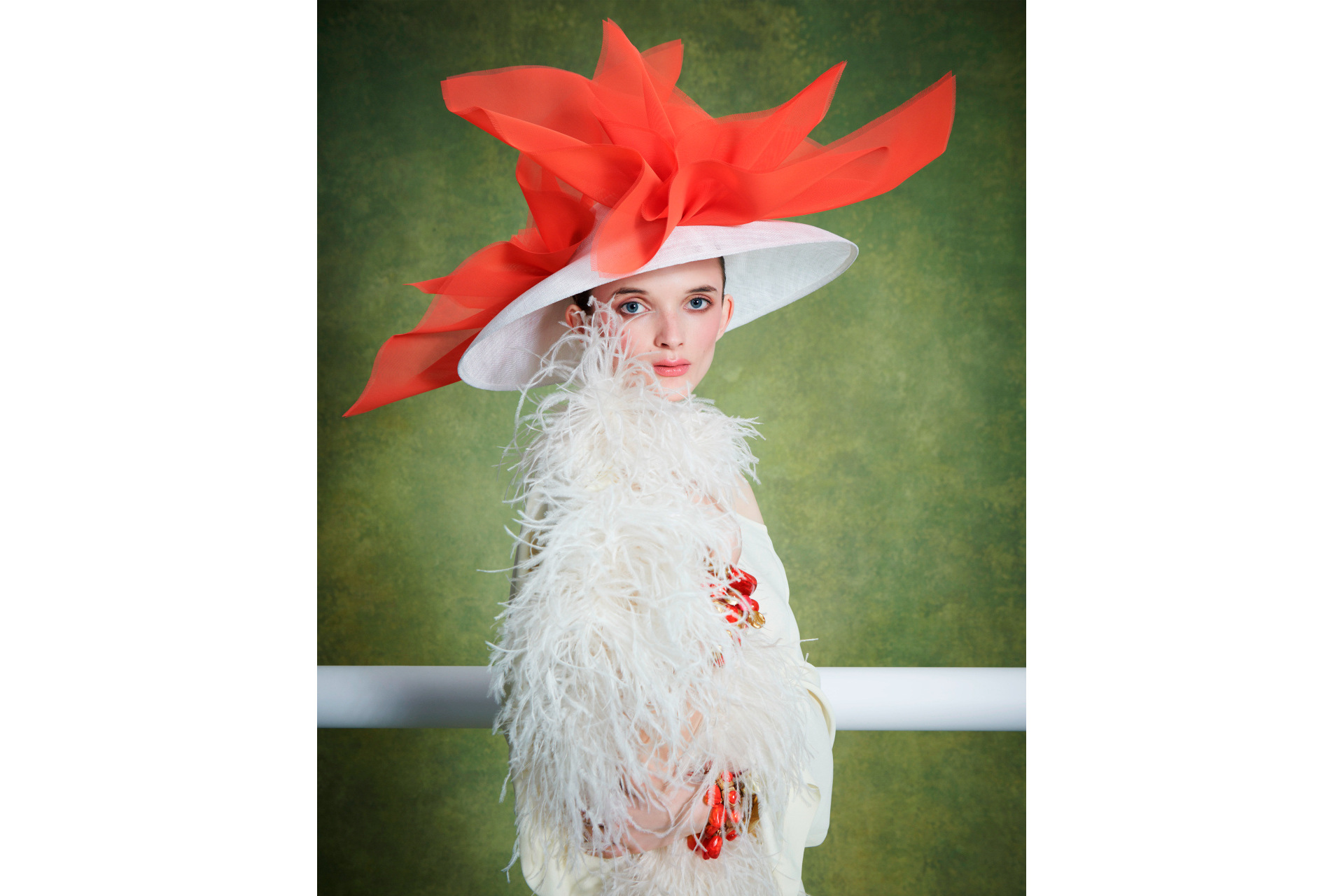 Woman in feather coat and white and red hat