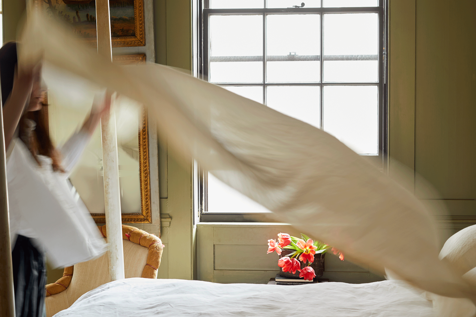 a woman changes bed linen East London Cloth