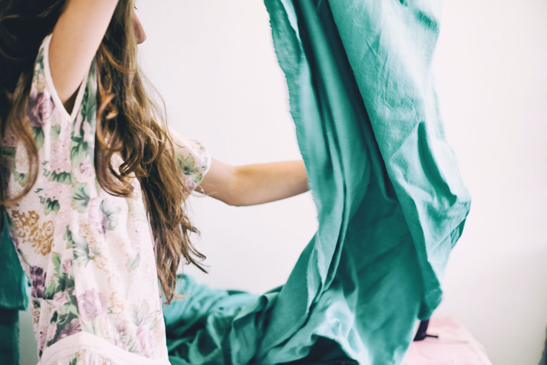 a woman cleans her living room and bedroom with sheets