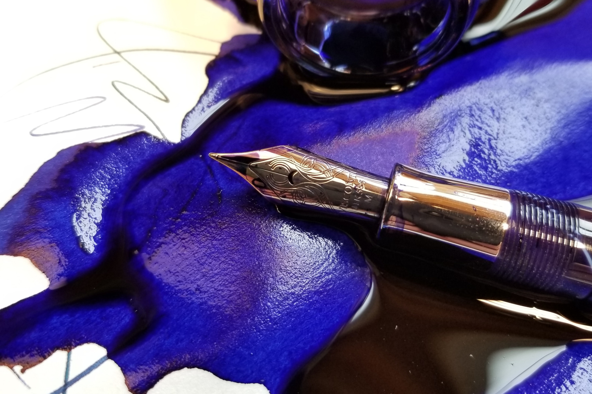 Fountain pen on top of spilled ink