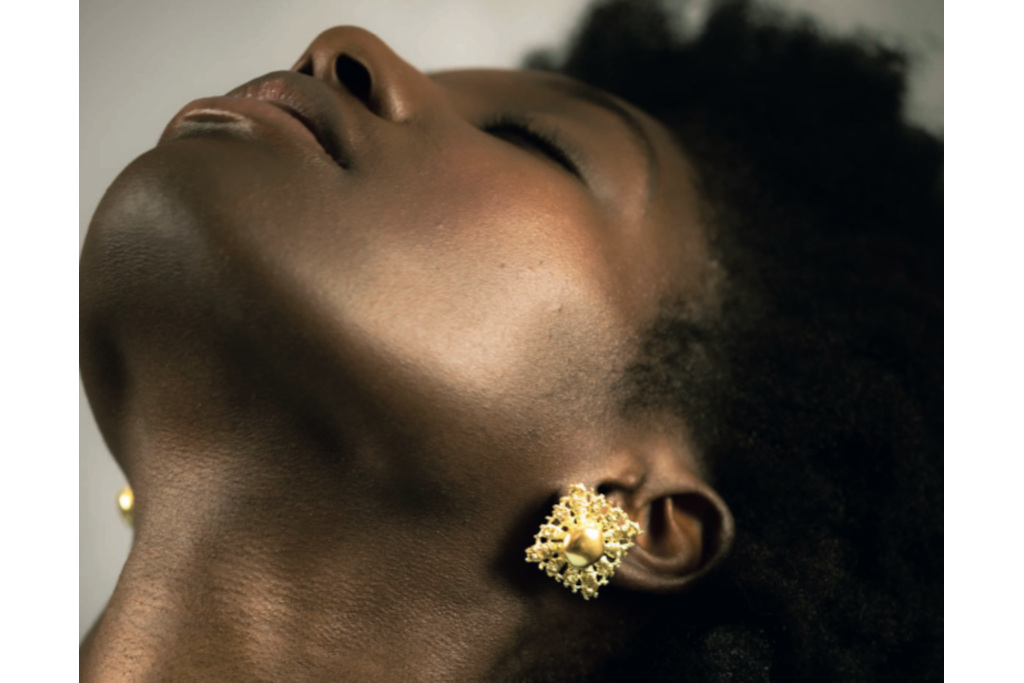 Model with head reclined to show off earrings