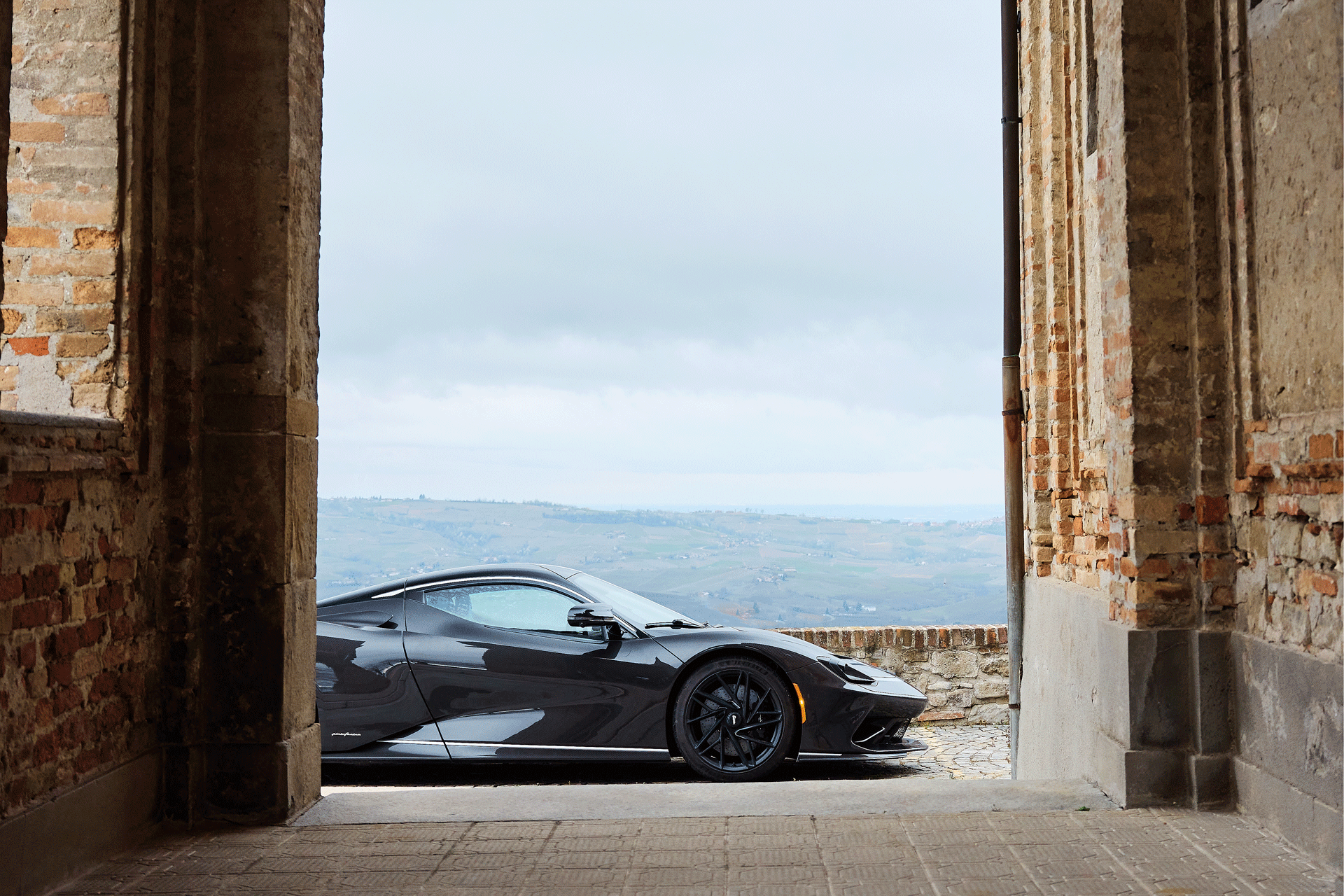 Side view of the Pininfarina Battista amongst an Italian ruin