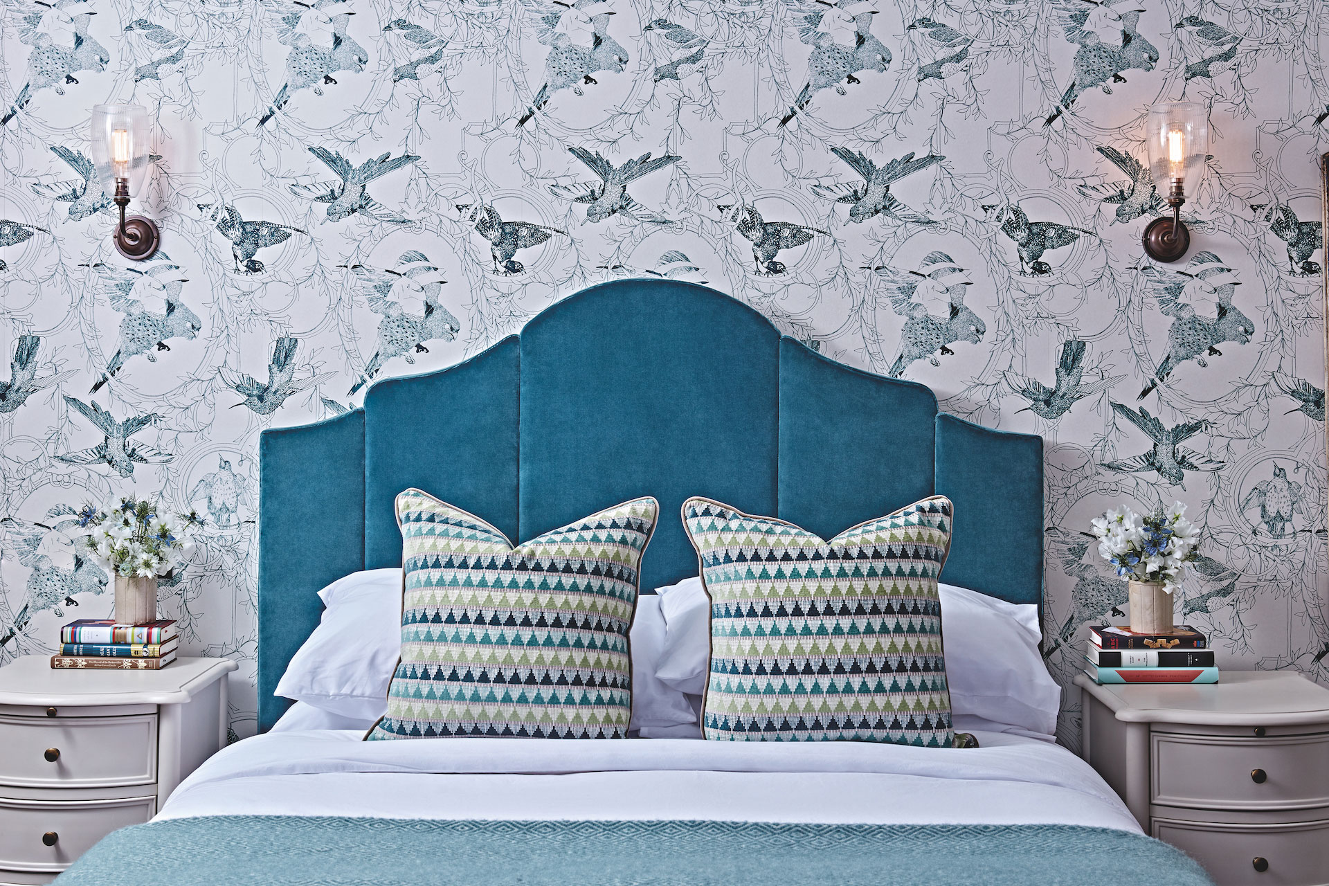 The Collective at Woolsery image of bed with blue headboard on patterned wallpaper Devon hotels