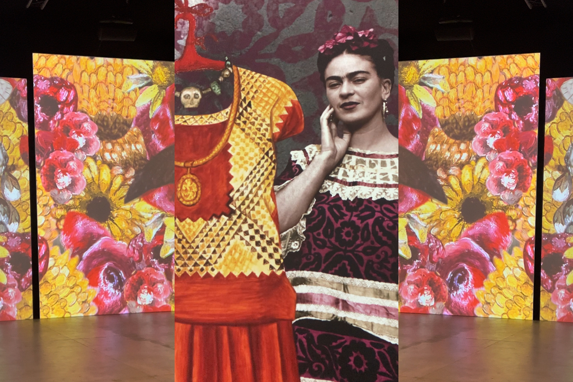 Three images (from L to R): photo of large screen depicting paintings of pink and yellow flowers, a photograph of Frida Kahlo collaged with one of her dresses, a mirror image of the first photo