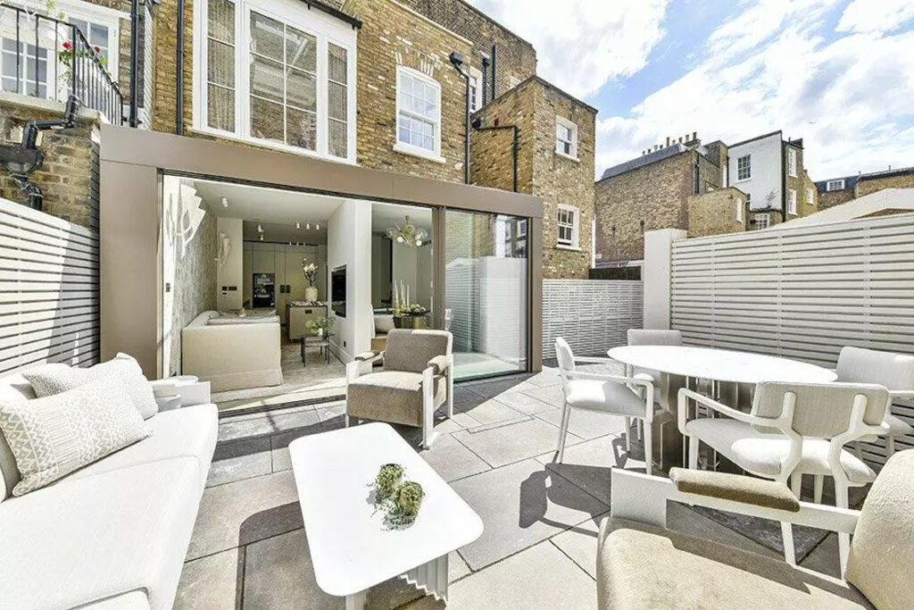 Back of family home with patio furniture, and view into the back of the house
