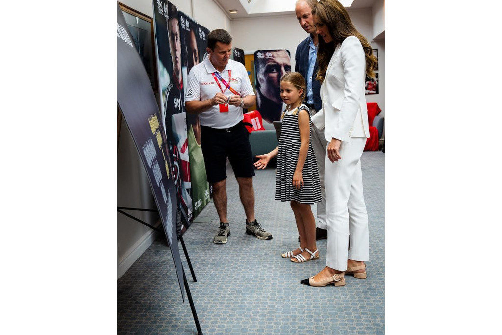 Kate Middleton, Prince William, Princess Charlotte and a man stood together at the Commonwealth Games 2022