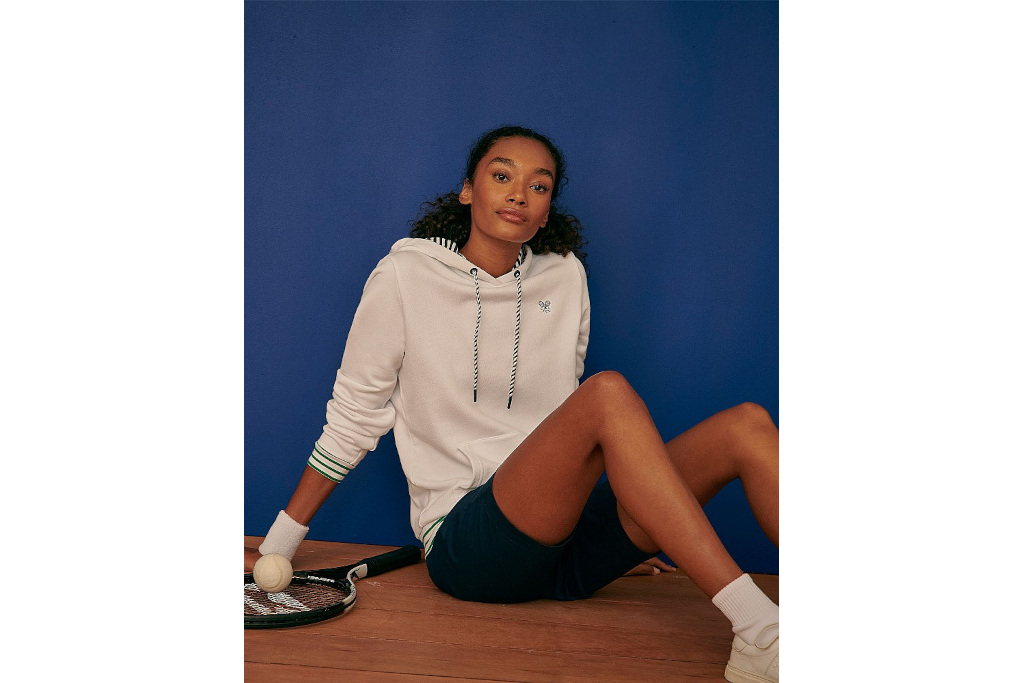 Woman in white hoodie and black shorts