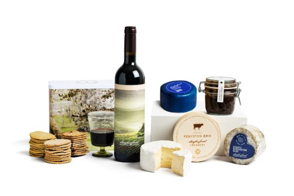 Spread of wine, biscuits and cheese on a white background