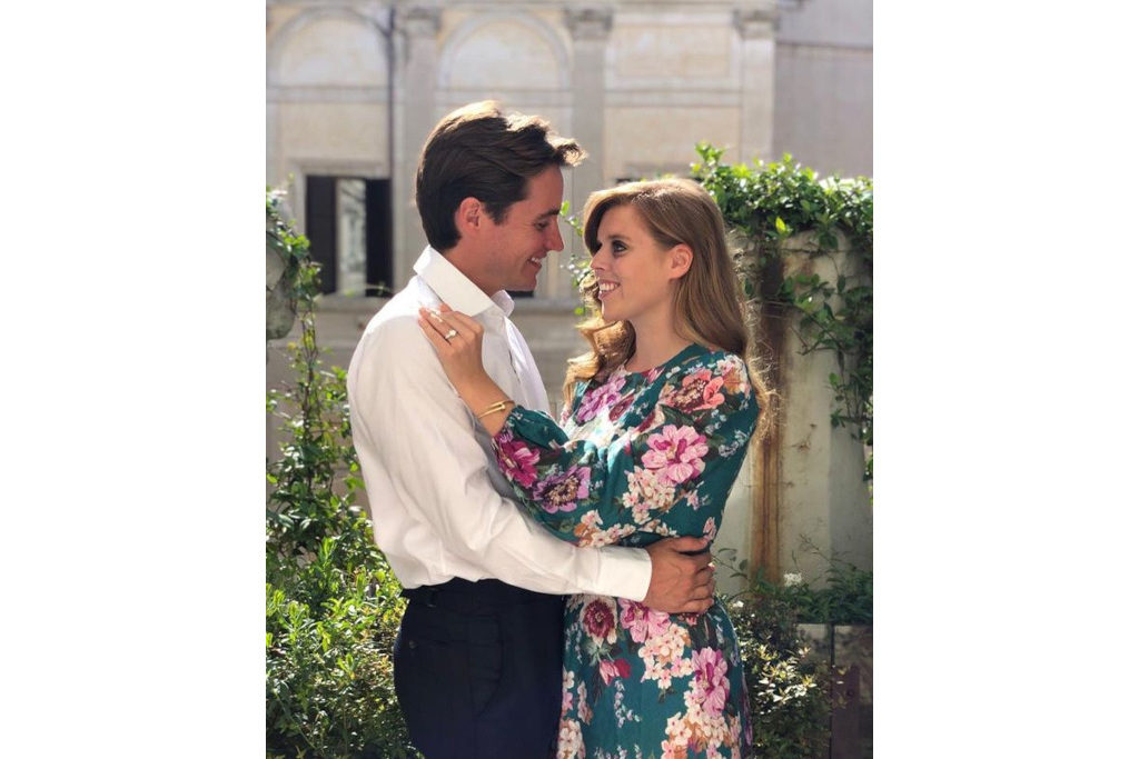 Princess Eugenie and Jack Brooksbank holding each other in front of a garden