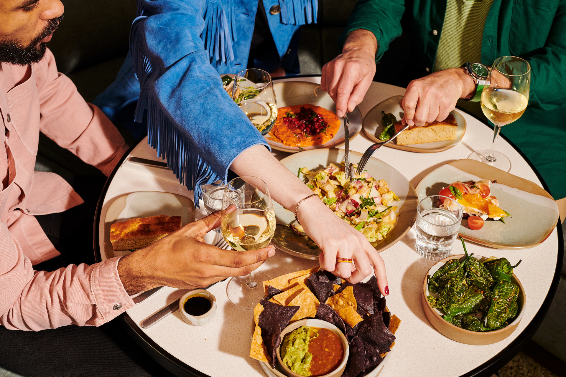 People sharing food over table