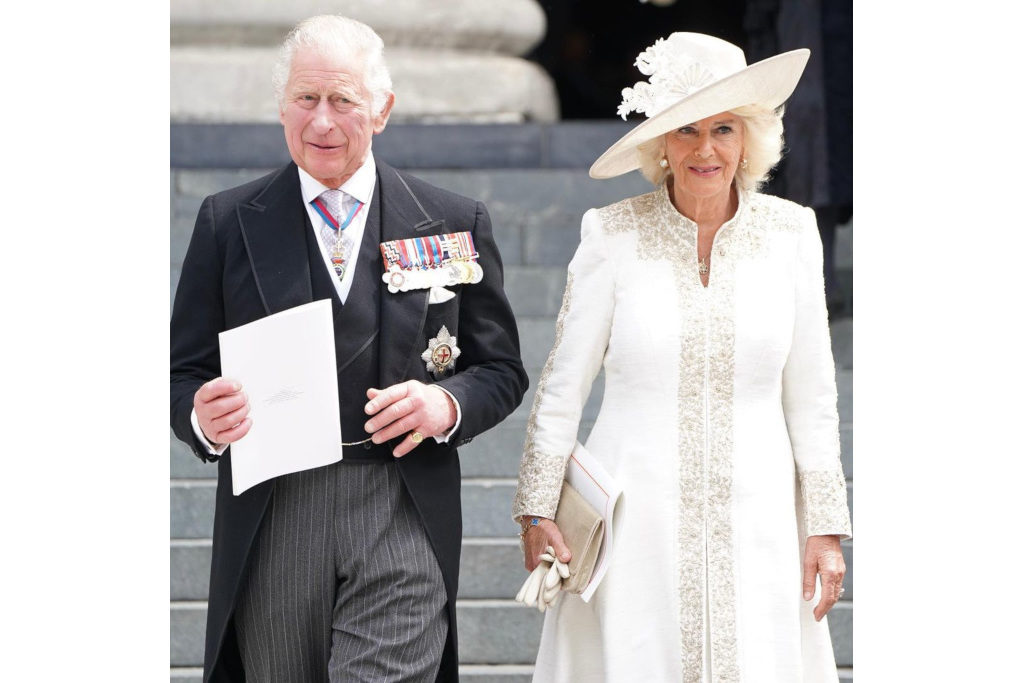 The Prince of Wales and the Duchess of Cornwall. Charles wears a suit with a tailcoat and Camilla wears a white dress and hat