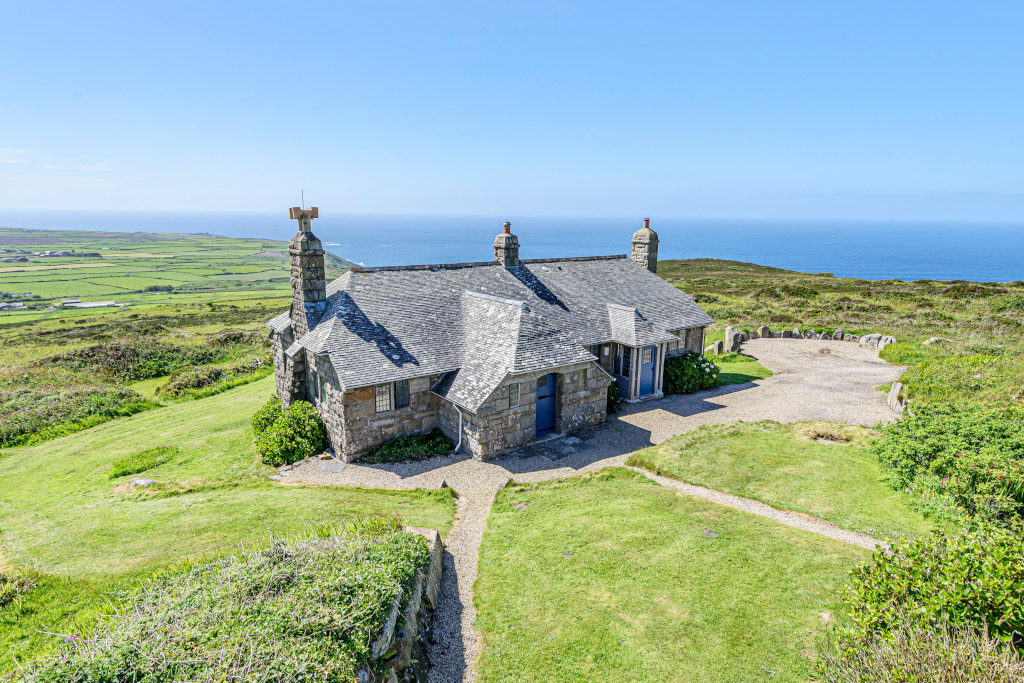 exterior shot of garden mine cottage surrounded by fields and with coastal views next to seaside in cornwall