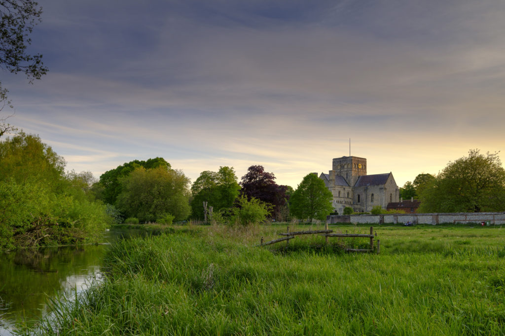 Spring sunset over St Cross Hospital and the River Itchen in Winchester, Hampshire, UK